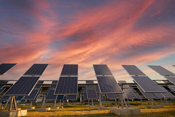 Solar panels against sundown sky
