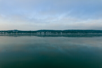 Beautiful view of the horizon of cloudy blue sky reflecting on water in Port of Klaipeda, Lithuania