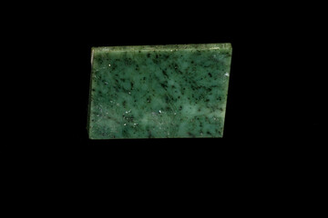 Nephrite mineral stone macro on a black background