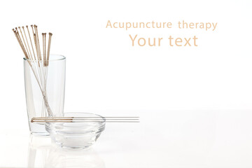 Silver needles for traditional Chinese acupuncture medicine. White background.