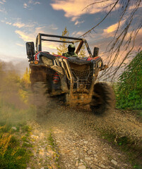 4x4 off-road corridors designed metal utility terrain vehicle car or truck drive by a driver with helmet during passing mud part of special section off road track. Dirt race concept © Arpan