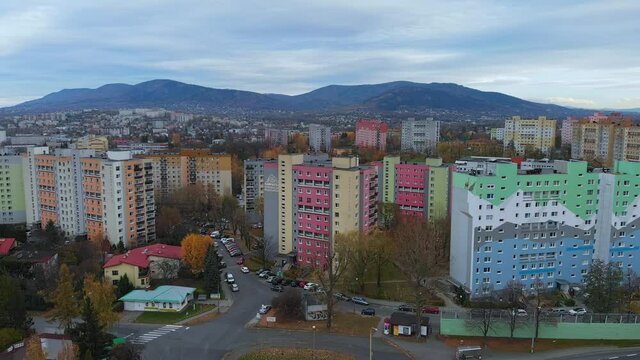Fly over blocks of flats in Bielsko Biala City. Pan right. View of mountains in background.