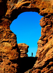 Turret Arch in Canyon Rock Formations Silhouetter of Hiker