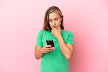 Young English woman isolated on pink background thinking and sending a message