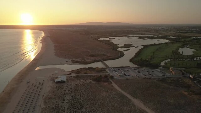 Aerial panoramic sunset seascape of Salgados beach in Albufeira, Algarve tourism destination region, Portugal.
