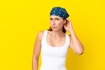 Young English woman isolated on yellow background having doubts