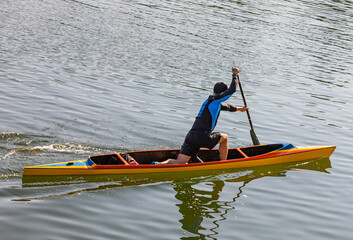 Man in rowing in canoe on the river. The hobby of active man is water sports.
