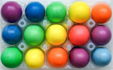 Bright multicolored Easter eggs laid in rows. Easter concept. Top view.