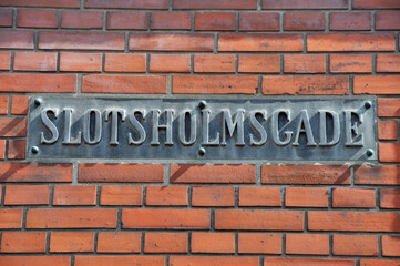 Obraz premium Altes Strassenschild Slotsholmsgade aus Metall auf Backsteinwand in Kopenhagen, Dänemark