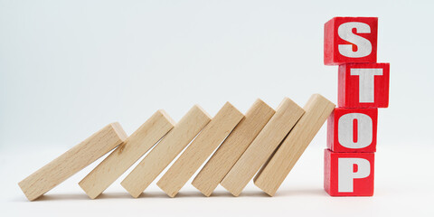 On a white background, wooden dice fell like dominoes, the fall was stopped by cubes with the...