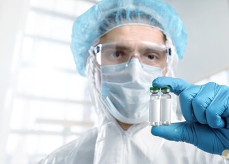 A doctor holding a vial with coronavirus Covid19 vaccine in hand.