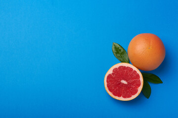grapefruit on blue background copy space