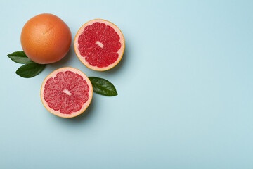 grapefruit on light blue background copy space