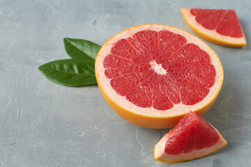 sliced grapefruit on grey background copy space