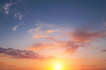 Fototapeta na wymiar Dramatic sunrise in the sky with bright sun and clouds.