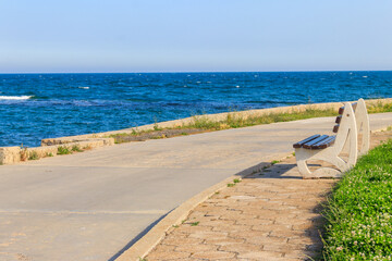 Fototapeta na wymiar Bench on the embankment of the sea