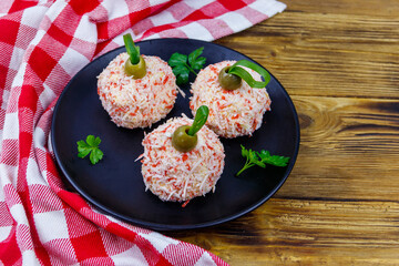 Appetizer of crab-cheese balls made in a shape of Christmas baubles on wooden table