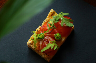 Tasty salmon sandwich on dark background