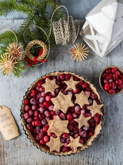 Christmas homemade cranberry pie, holiday baked goods on wooden backghround ,vertikal shot.