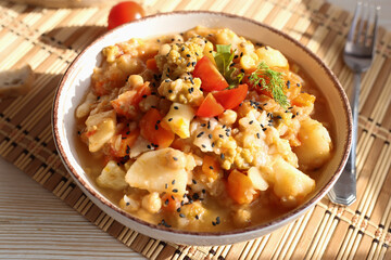 Healthy homemade vegan food concept. Stew organic vegetables ragout french ratatouille in stewpan on a cozy kitchen table. 