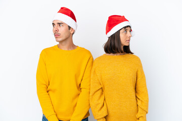 Fototapeta premium Young mixed race couple celebrating Christmas isolated on white background nervous and scared