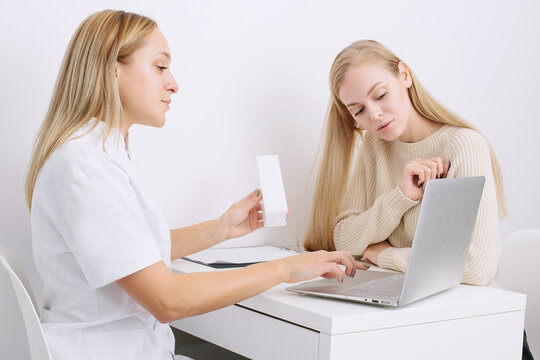 Consultation in cosmetology clinic. Female professional beauty doctor talking with pretty young female.