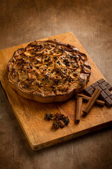 apple cake with cinnamon stick and chocolate over wood