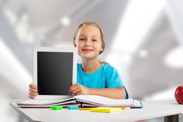 Fototapeta na wymiar Small junior school kid student using digital tablet