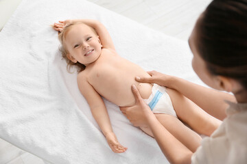 Obraz na płótnie Canvas Massage therapist working with baby in medical center