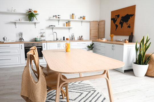 Stylish kitchen interior with wooden dining table