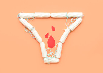 Menstrual tampons and paper blood drops on color background