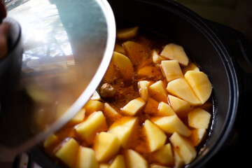 Cooking. Cast iron cauldron with stewed potatoes with meat and vegetables, with the lid up
