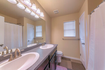 Bathroom interior with double vanity sink and window