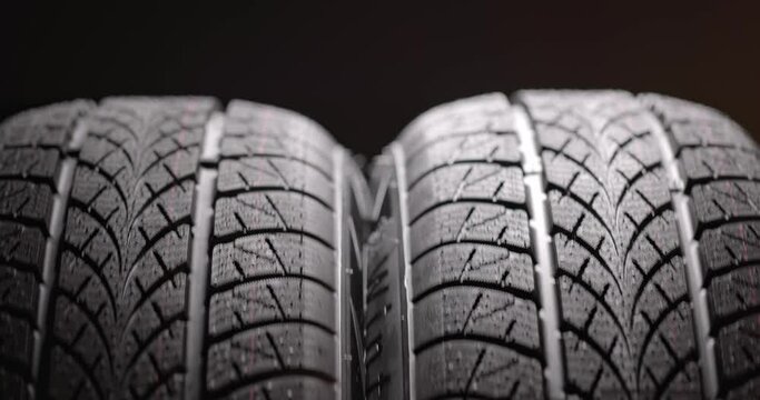 Clean car tyres spinning against dark background