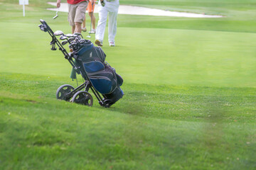 Golf blue bag and trundler on golf course