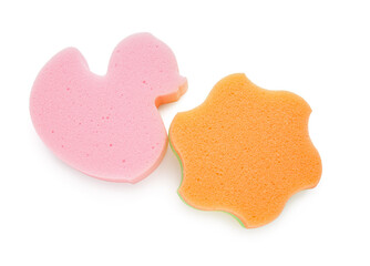 Cute duck and star shaped bath sponges on white background