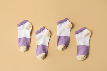 Soft cotton socks on color background