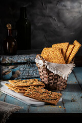 Croutons with cheese in a wicker basket and on a wooden table