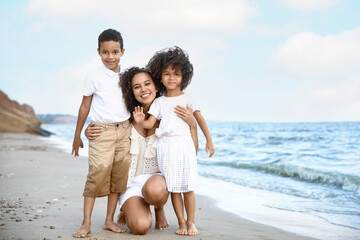 African-American children with mother on sea beach