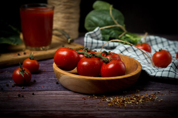 cherry tomatoes and tomato juice on a black background. Tomato cocktail with tomatoes