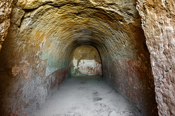 Tunnel in underground settlement of Buddhist monks on Kara-Tepe hill, Termez, Uzbekistan. Although room has been uninhabited for more than 15 centuries, walls can still be painted red and white