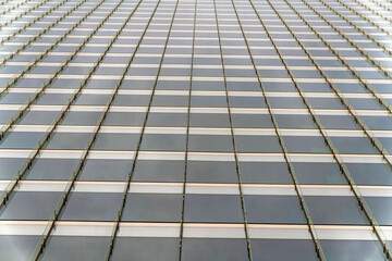 Tinted glass curtain wall of a building with vertical glass beams at Salt Lake City, Utah