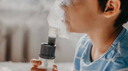 sick child breathes in a nebulizer - obrazy, fototapety, plakaty