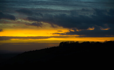 scenic Westerly view as the golden sun sets over Oare and across the Pewsey Vale valley, North Wessex Downs AONB