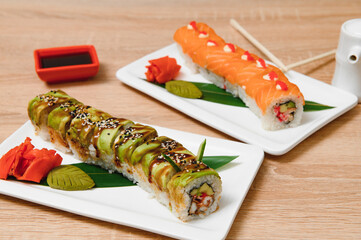 Japanese rolls on black background isolated with reflections