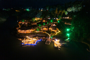 night aerial capture of village with many lights on a lake