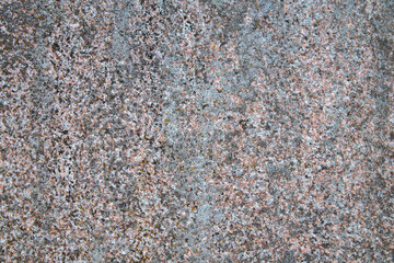 background of red stone overgrown with moss