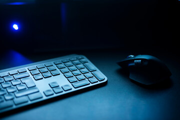 computer mouse and keyboard.
pc gaming keyboard with mouse illuminated with blue light. 