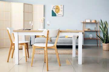 Interior of light dining room with folding screen