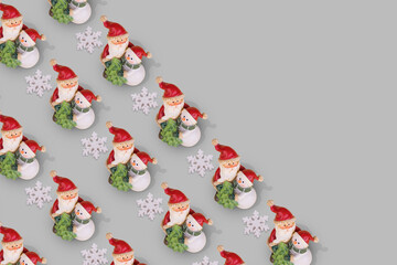 Creative Christmas pattern with Snowman and Santa Claus  in an embrace on a gray background.